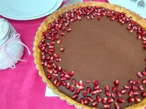 Chocolate Tart topped with pomegranate seeds.