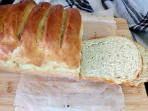 Loaf of Bread with a sliced piece next to it.