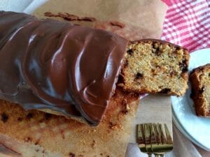 Sliced Carrot Cake with Chocolate Chips on a wooden board.