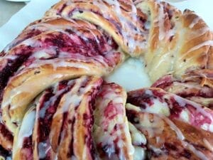 Berry Jam Wreath with Lemon Glaze on a baking parchment.