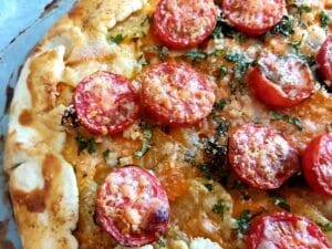 Close up of baked potato and tomato galette
