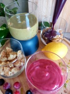 Piping fruit curd onto crumbled sponge cake in a glass.