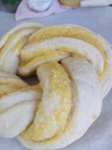 a dough filled with mango curd, twisted and shaped into a wreath