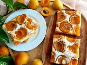 Clafoutis-Inspired Summer Traybake with fresh apricots and creamy custard.