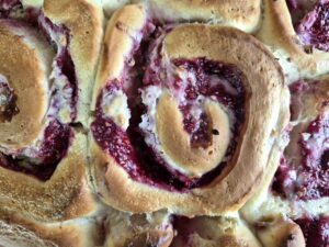 Close-up of golden baked raspberry rose rolls