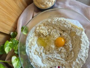 Dry baking ingredients and one egg in a mixing bowl.