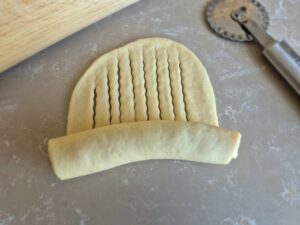 Rolling technique for scored sweet bread with chocolate filling.