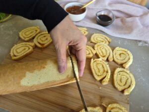 Swiss roll being sliced thinly.