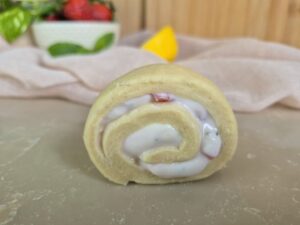 Close-up of an unbaked strawberry-mint cheesecake roll.