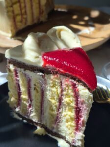 A slice of Raspberry Vanilla Rolled Layer Cake
