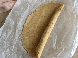 Crumbly streusel dough rolled into a log shape.