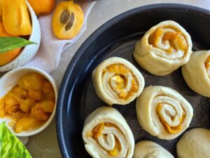 Close-up of sliced Apricot Honey Rolls in a baking dish ready for the oven 