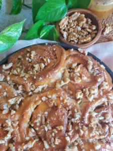 Walnut Caramel Cinnamon Rolls drizzled with homemade caramel sauce.