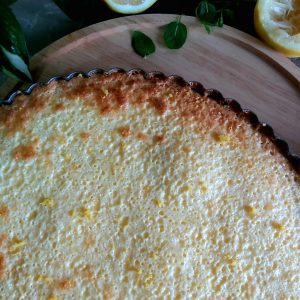 Baked lemon tart on a wooden platter