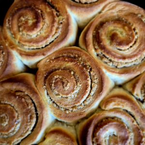 Close-up of golden baked walnut, orange & mahleb rolls.