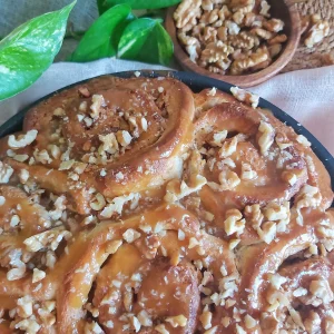 Walnut Caramel Cinnamon Rolls drizzled with homemade caramel sauce.